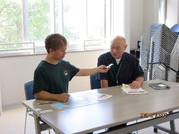 コミュニティ放送から取材を受けるコミュニティ職員