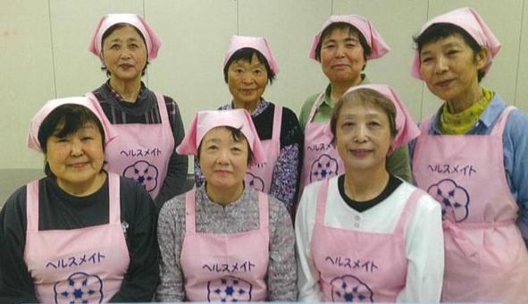 写真:ピンクのエプロンをつけた7人の食生活改善推進員