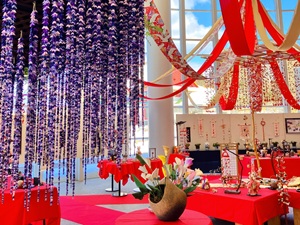 天井から吊り下げられた藤の花などのつるし雛の写真