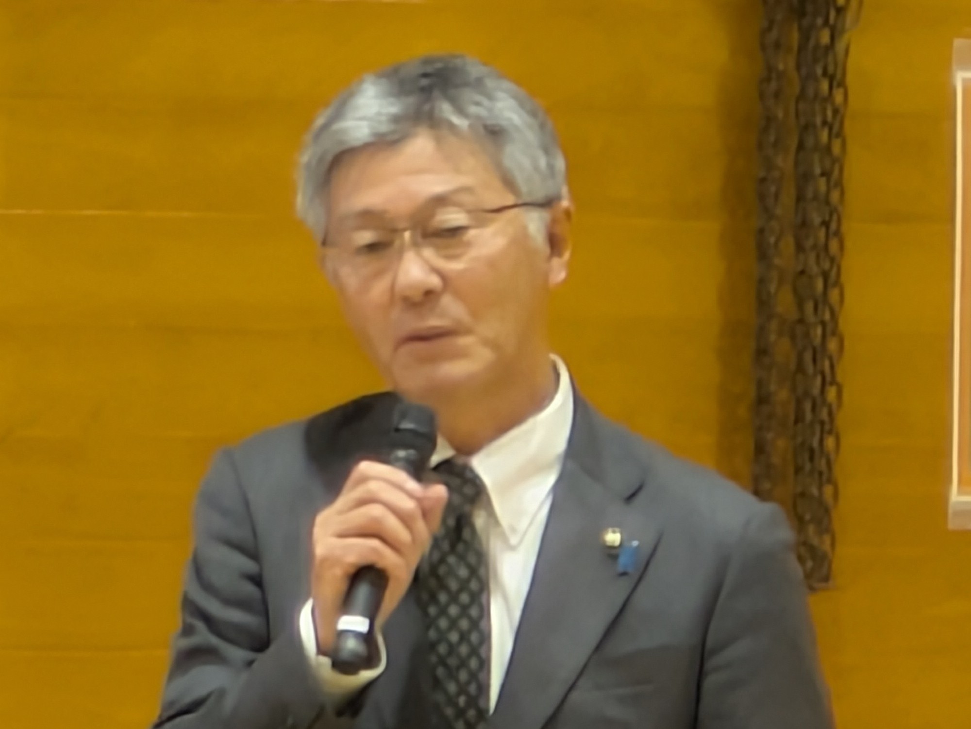 写真：マイクを持ち住民の皆さんと意見交換を行う市長