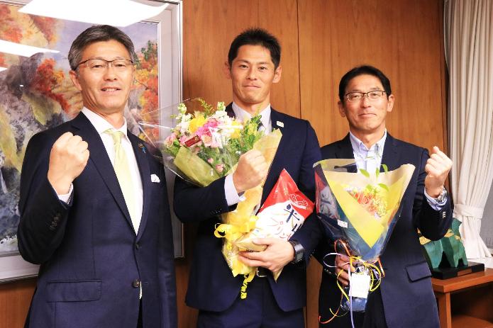 花束と米山プリンセスを手にする富澤選手とガッツポーズをする櫻井市長
