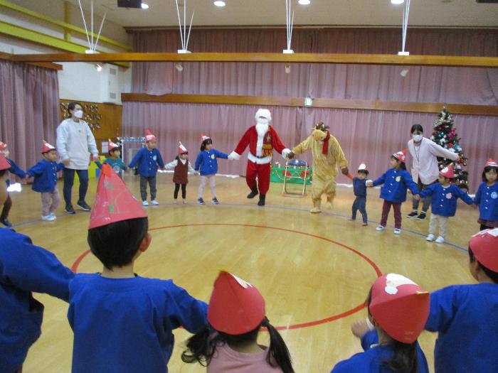 写真：サンタさんと手をつないで大きく羽になり、一緒にダンスをした子どもたち