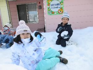 写真：大きめの雪玉を抱える子、手のひらサイズの雪玉を作る子と、3歳児が雪遊びをしています