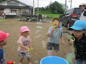 写真：子どもたちがシャボン玉を吹いて楽しそうに遊んでいる様子
