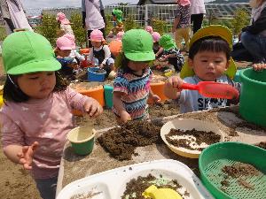 写真：砂場でおままごとをしている男の子と女の子