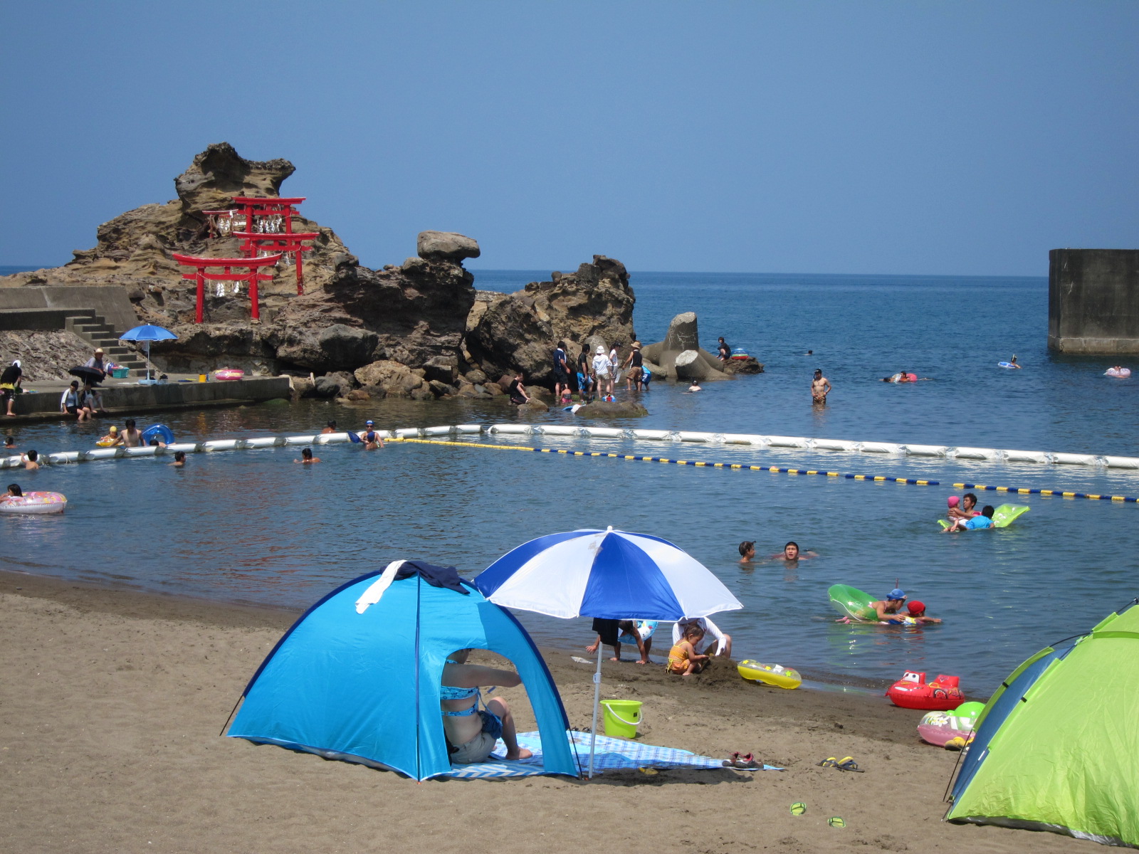 笠島海水浴場の様子。写真左奥に赤い鳥居の建つ岩場があります。