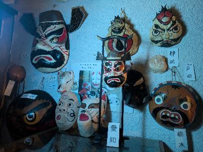 写真：薄暗い館内にお面が飾られている写真