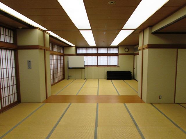 障子とベージュ色の壁で囲まれた二間の畳敷きの和室の写真