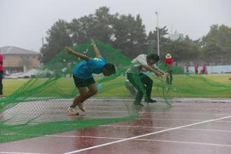 写真：2人の参加者が障害物レースのネットくぐりをする様子