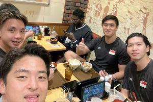 写真：シンガポール男子選手3人とブルボンKZ男子選手が同じテーブルで食事しています