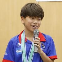 写真：キャプテンの笹川選手がマイクを持って話しています