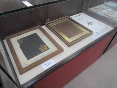 写真：ガラスケースの中に、松平定信の筆跡や装束が額装されたものが飾られています。