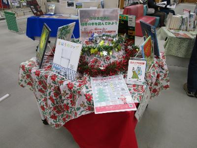 写真：赤色や緑色のモールでクリスマスを演出した特設コーナー。科学に関する本が並んでいます。