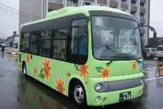 黄緑色の車体にひまわりのイラストが描かれた東循環バス「ひまわり」の写真
