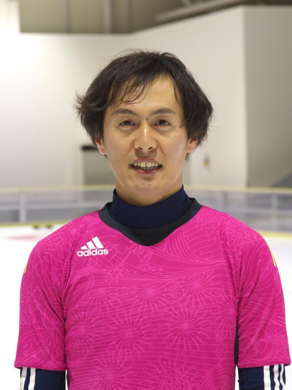 ピンク色のユニホームを着た山田 拓郎さんの上半身の写真